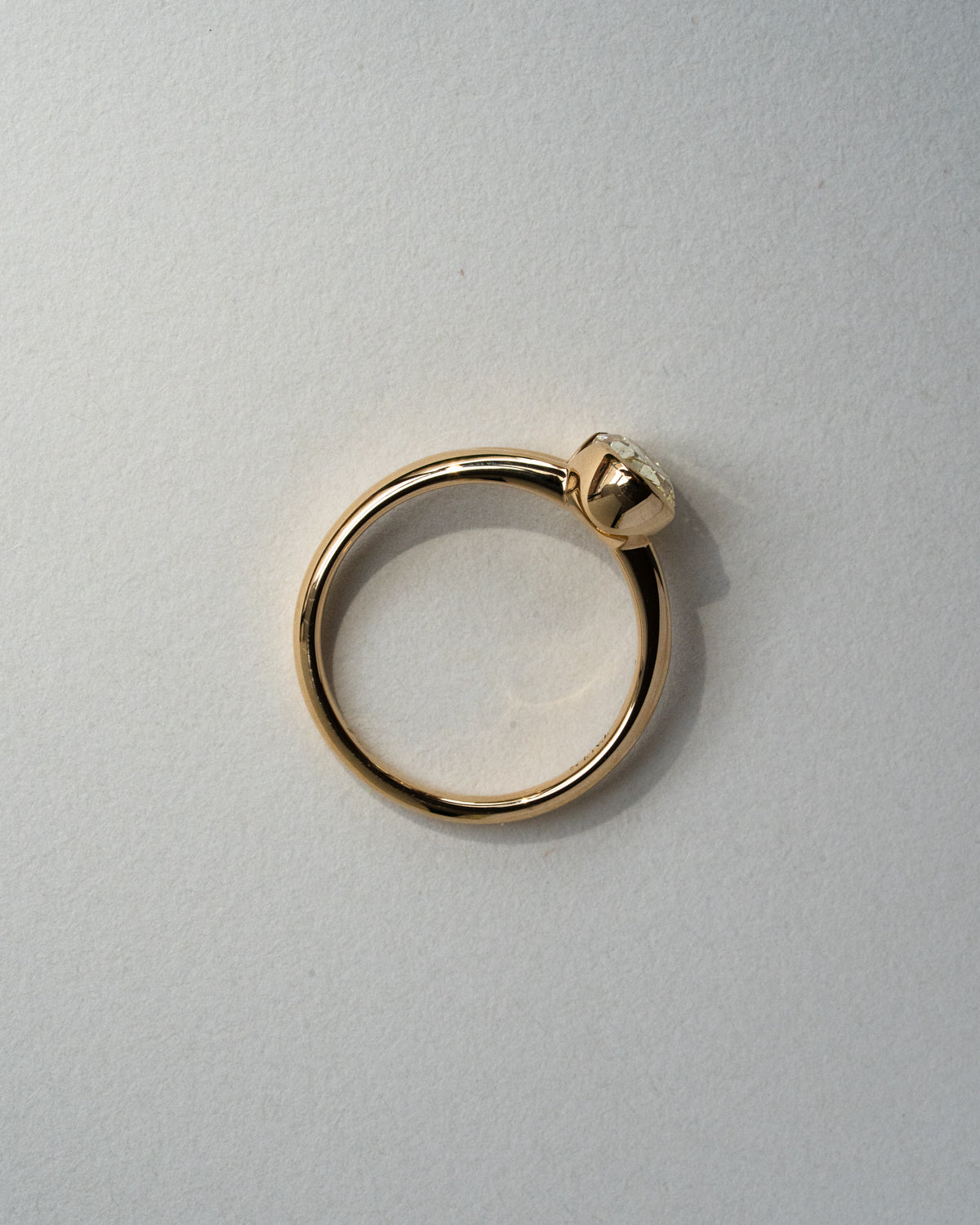 Oval yellow diamond with half bezel