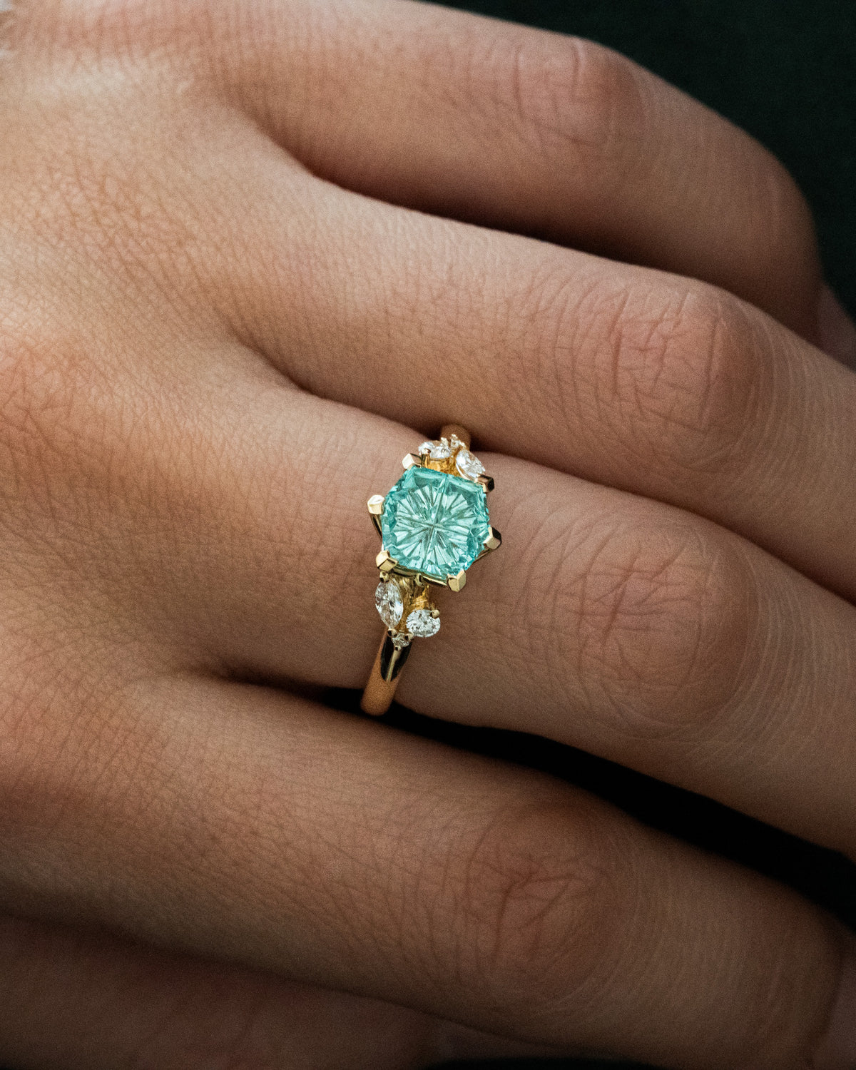 Aqua hexagon sapphire with leafy side stones