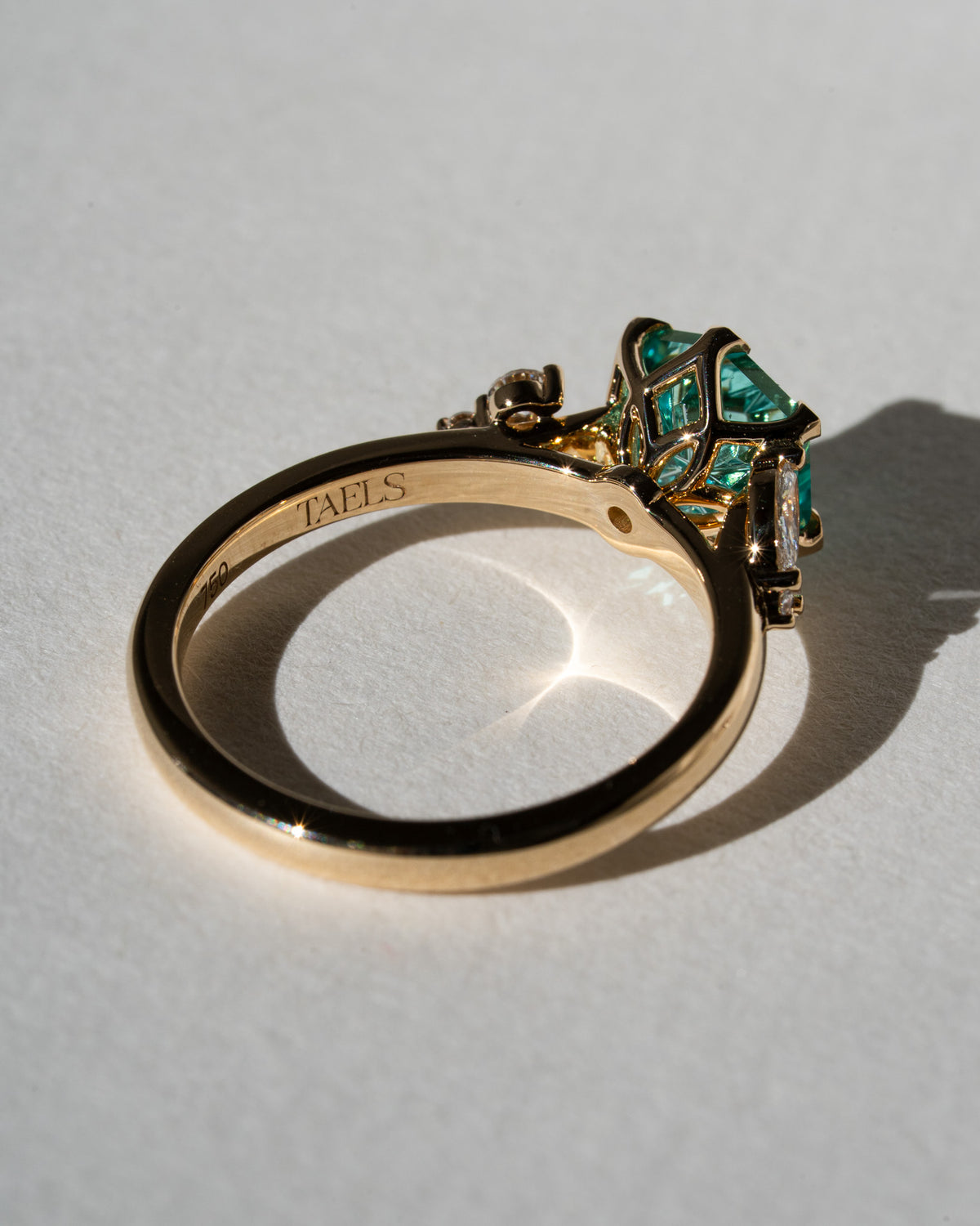 Aqua hexagon sapphire with leafy side stones