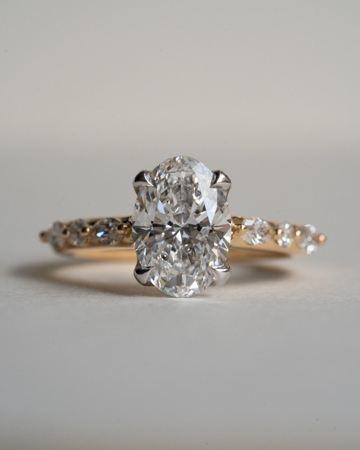 Oval diamond engagement ring with floral basket, 18ct yellow gold band and white gold setting