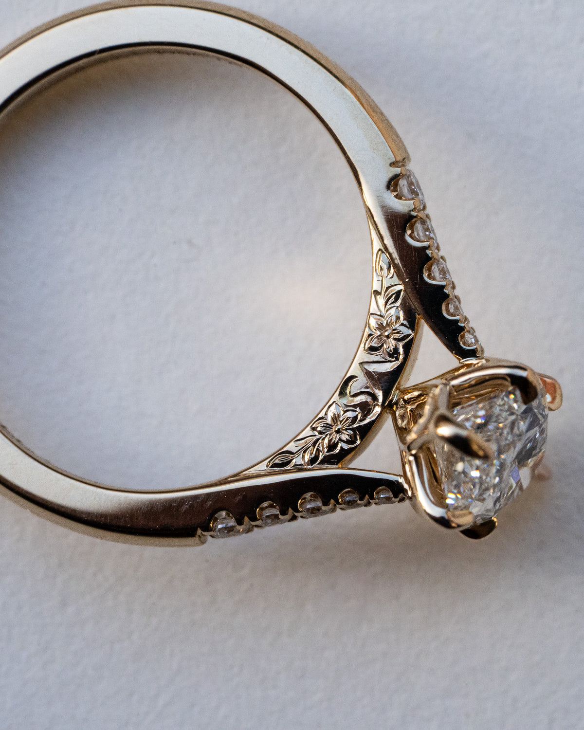 Marquise diamond with pavé shoulders and floral engraving