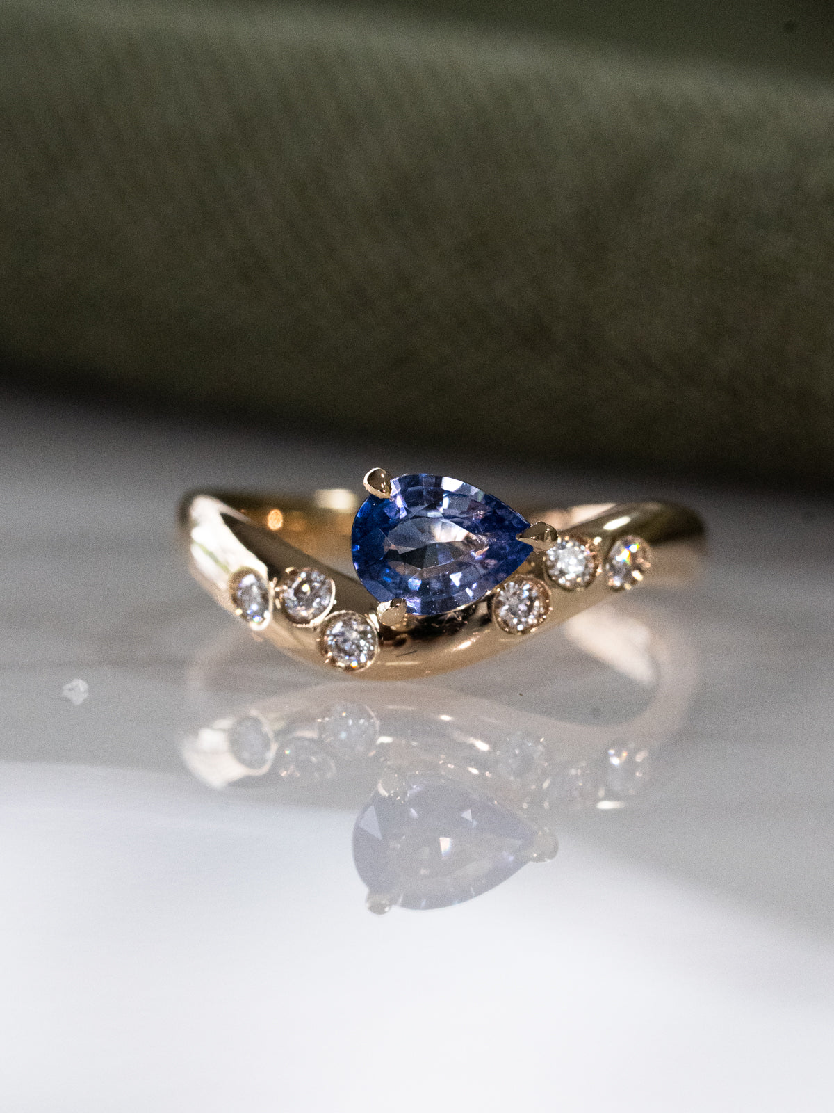 Blue Sapphire Wave Ring with Scattered Diamonds